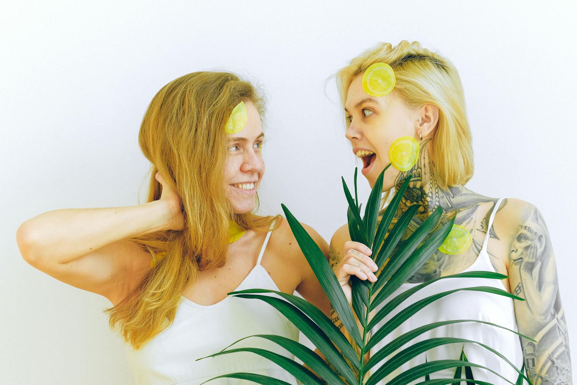 Two smiling women expressing joy and connection indoors with vibrant energy