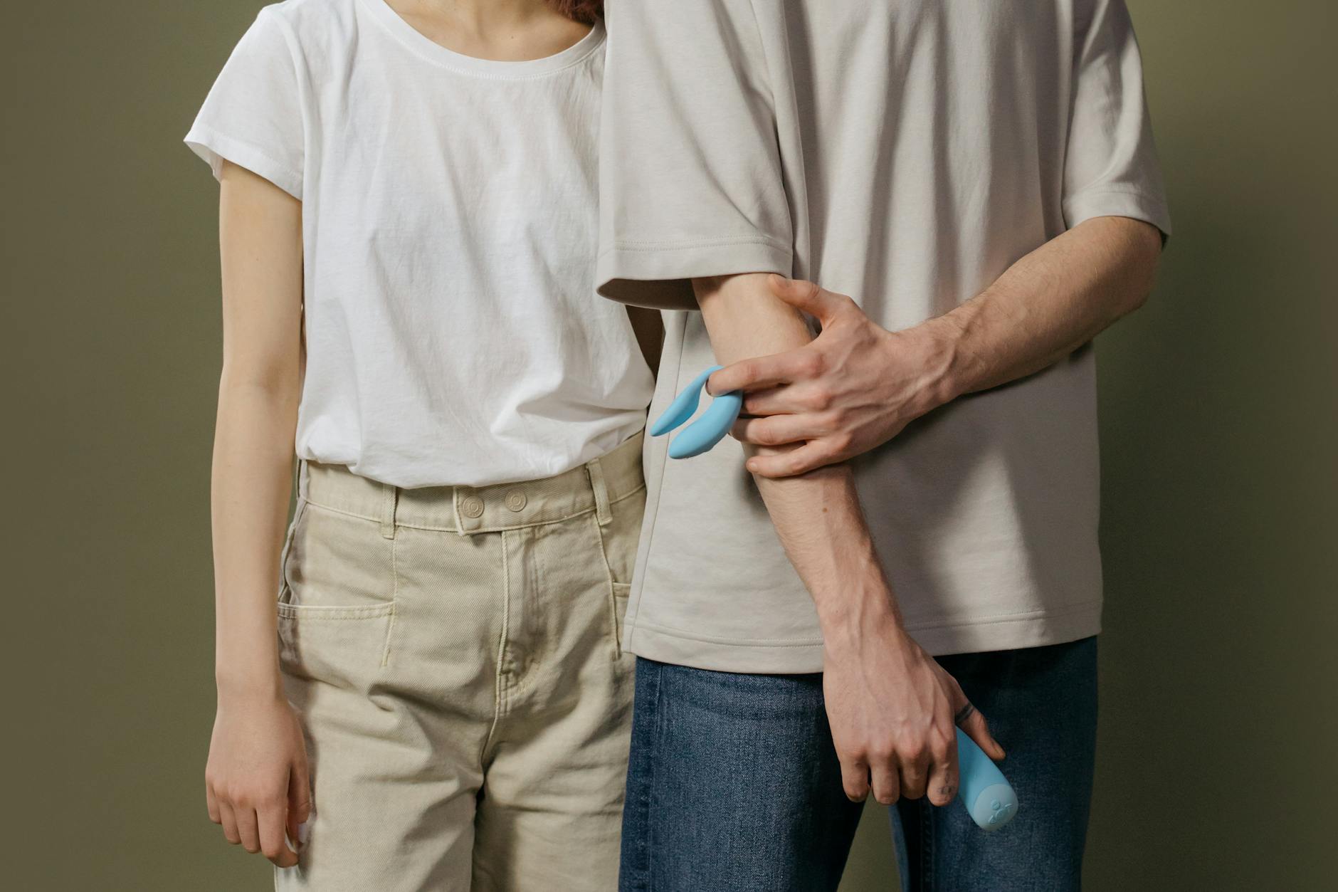 Woman contemplatively holding multiple vibrators, showing different options for pleasure